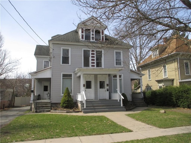 57-59 Maple St, Oneonta-City, NY 13820 - traditional style home featuring a shingled roof, a porch, and a front lawn