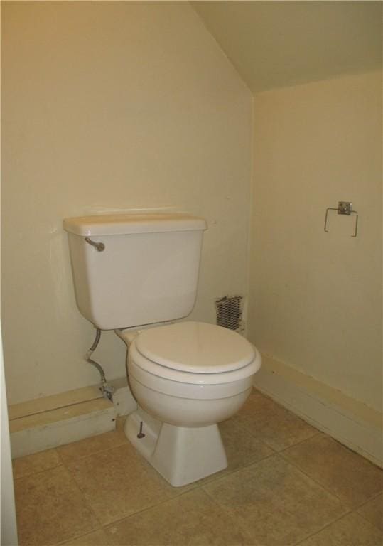 57-59 Maple St, Oneonta-City, NY 13820 - bathroom featuring tile patterned flooring, baseboards, vaulted ceiling, and toilet