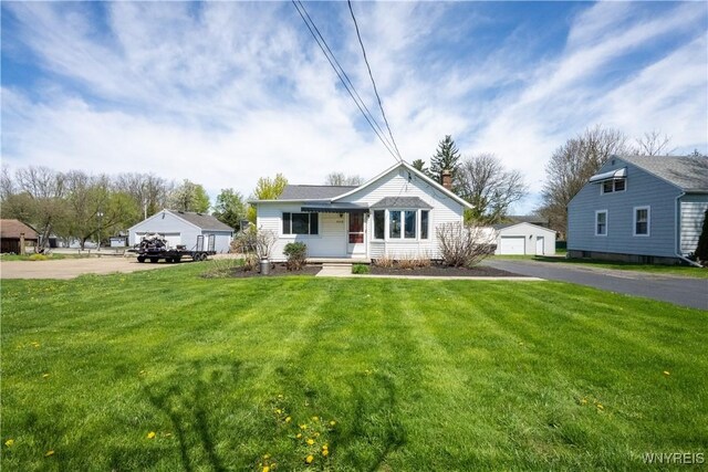 bungalow-style house featuring a garage, a front lawn, and a chimney