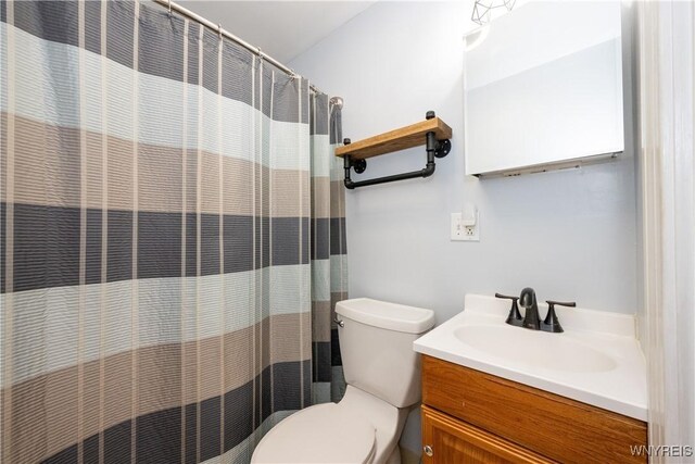 bathroom with vanity, toilet, and a shower with curtain