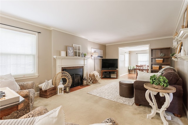 living area with carpet floors, baseboards, ornamental molding, and a fireplace