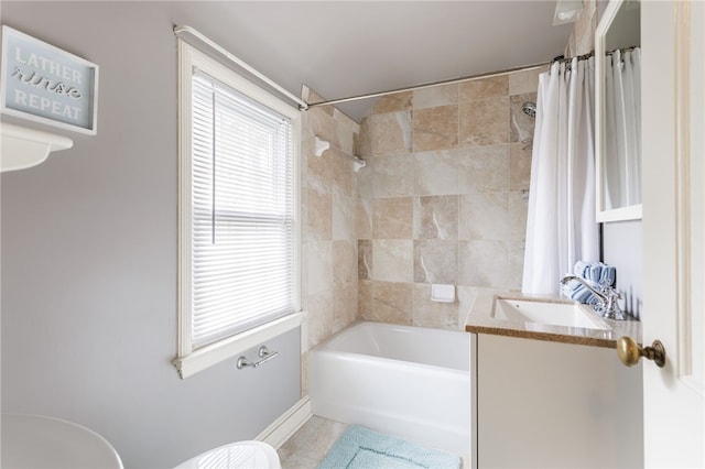 full bathroom featuring tile patterned flooring, baseboards, vanity, toilet, and shower / bathtub combination with curtain
