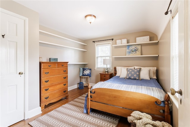 bedroom featuring baseboards and wood finished floors