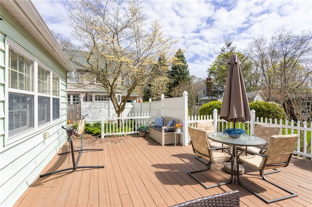 wooden deck featuring a fenced backyard and outdoor dining area