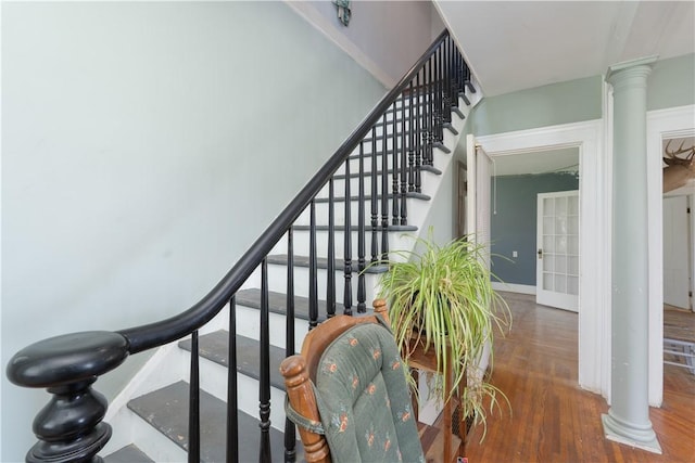 9 Porter St, Prattsburgh, NY 14873 - stairway with ornate columns, baseboards, and wood finished floors