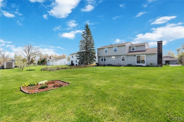 4765 Rosemary Ln, Clay, NY 13088 - back of property featuring a lawn, an outdoor structure, a chimney, and a shed