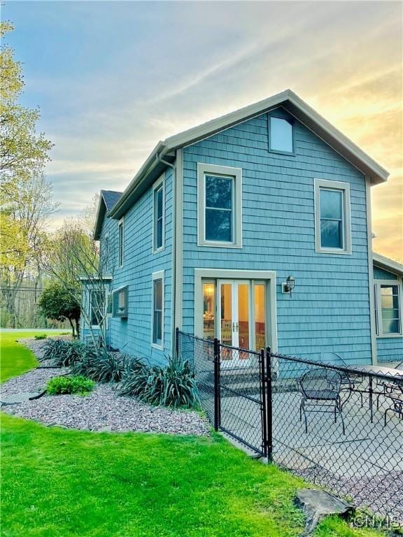 1058 State Route 48, Granby, NY 13069 - back of property at dusk featuring fence, a yard, and french doors