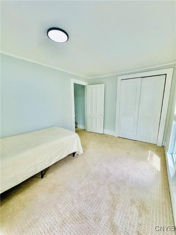 1058 State Route 48, Granby, NY 13069 - bedroom featuring a closet, carpet, crown molding, and baseboards