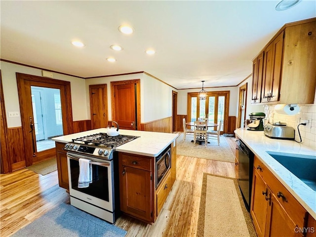 1058 State Route 48, Granby, NY 13069 - kitchen featuring built in microwave, wainscoting, dishwasher, stainless steel gas range, and light wood finished floors