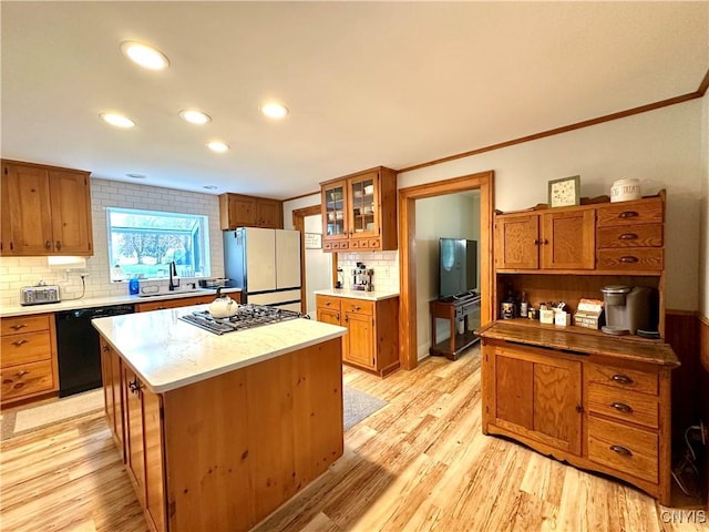 1058 State Route 48, Granby, NY 13069 - kitchen with tasteful backsplash, brown cabinets, freestanding refrigerator, stainless steel gas stovetop, and black dishwasher