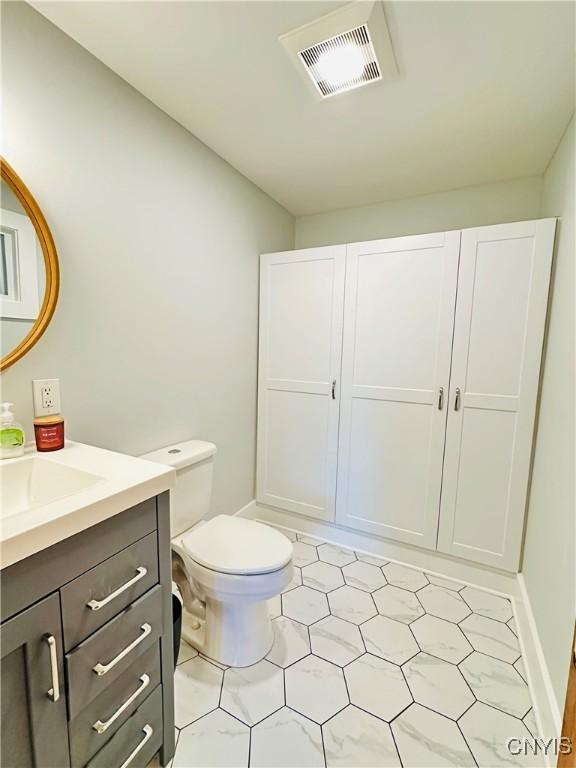 1058 State Route 48, Granby, NY 13069 - bathroom featuring toilet, tile patterned floors, visible vents, and vanity
