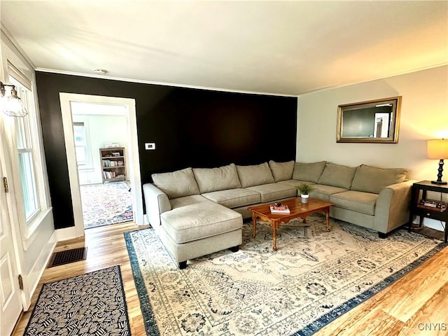 1058 State Route 48, Granby, NY 13069 - living room with visible vents, ornamental molding, baseboards, and wood finished floors
