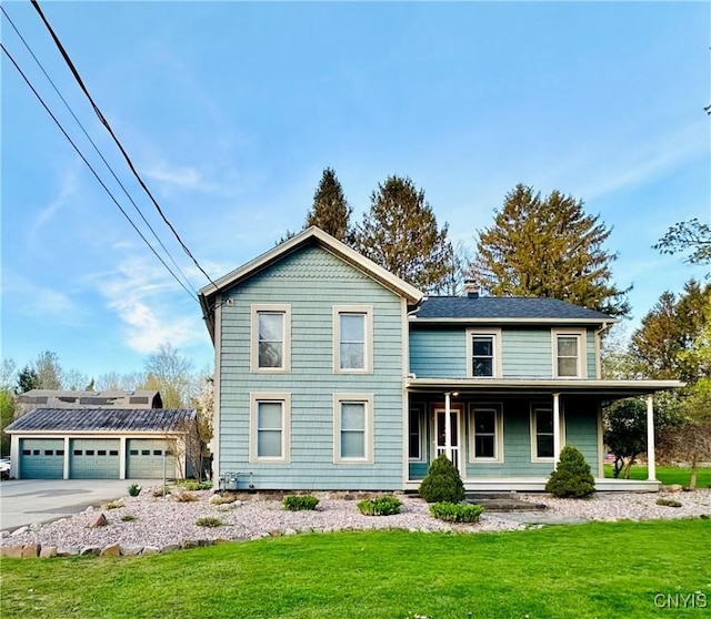 1058 State Route 48, Granby, NY 13069 - view of front of property featuring a front lawn, a garage, a chimney, concrete driveway, and covered porch