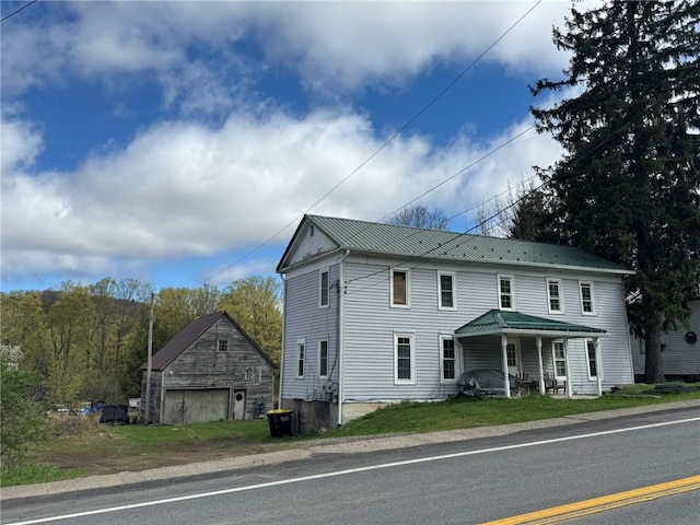 2129 State Highway 206, Masonville, NY 13849 - colonial home with covered porch, an outbuilding, metal roof, and a garage