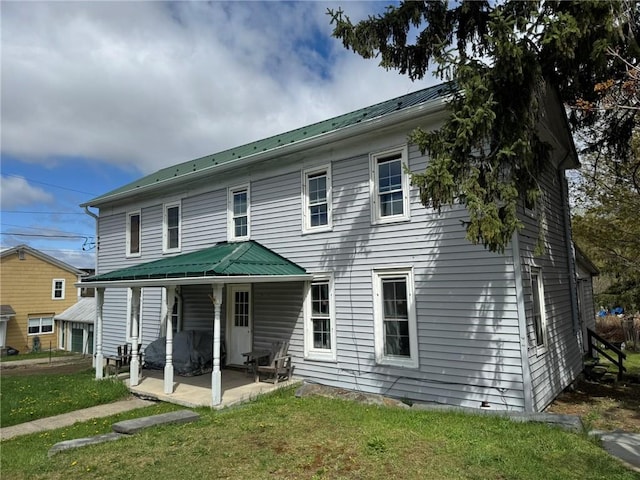 2129 State Highway 206, Masonville, NY 13849 - back of property featuring a lawn, metal roof, and a patio area