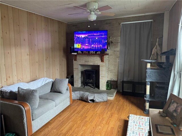 2129 State Highway 206, Masonville, NY 13849 - living area with wooden walls, ceiling fan, a fireplace, and wood finished floors