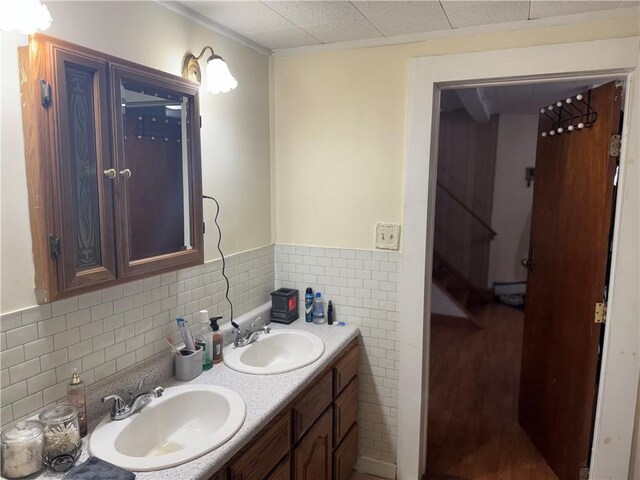 2129 State Highway 206, Masonville, NY 13849 - full bath with double vanity, a sink, wood finished floors, and tile walls