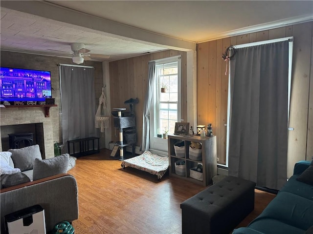 2129 State Highway 206, Masonville, NY 13849 - living area featuring a ceiling fan, wood finished floors, wooden walls, and a fireplace