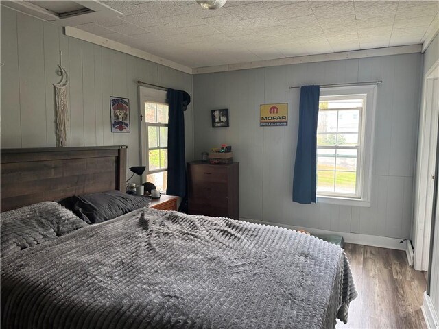 2129 State Highway 206, Masonville, NY 13849 - bedroom featuring baseboards, wood finished floors, and wooden walls