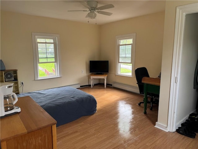 2129 State Highway 206, Masonville, NY 13849 - bedroom featuring a ceiling fan, a baseboard heating unit, and wood finished floors