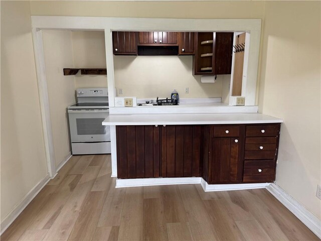 2129 State Highway 206, Masonville, NY 13849 - kitchen with open shelves, dark brown cabinets, light countertops, electric stove, and light wood-style floors