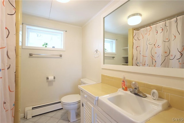 bathroom with crown molding, vanity, toilet, baseboard heating, and tile patterned floors