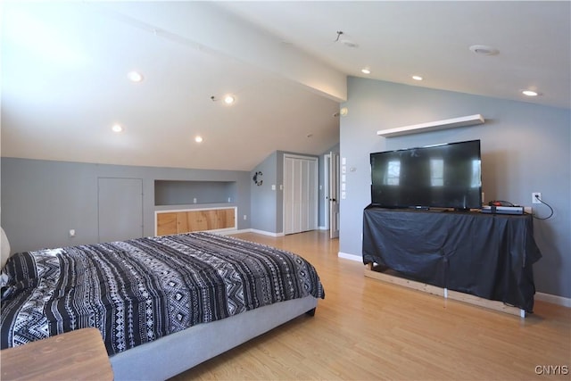 bedroom with baseboards, vaulted ceiling, recessed lighting, and wood finished floors