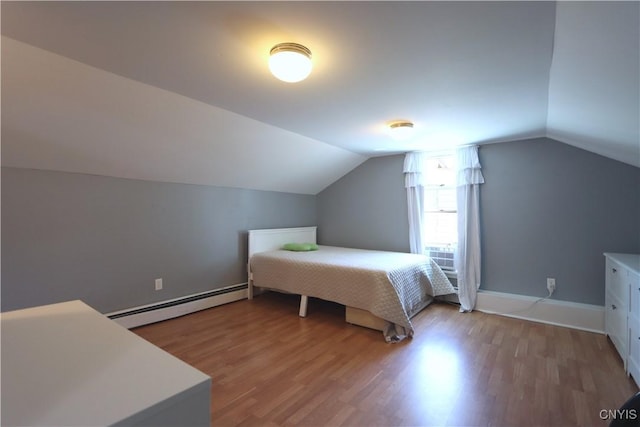 bedroom with baseboards, vaulted ceiling, baseboard heating, and light wood-style floors