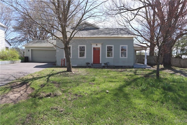view of front of house with a garage, fence, driveway, and a front yard