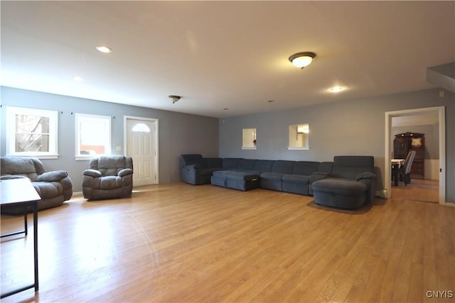 living area with recessed lighting and light wood finished floors