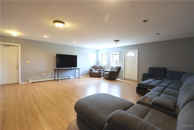 living room featuring baseboards, baseboard heating, and light wood finished floors