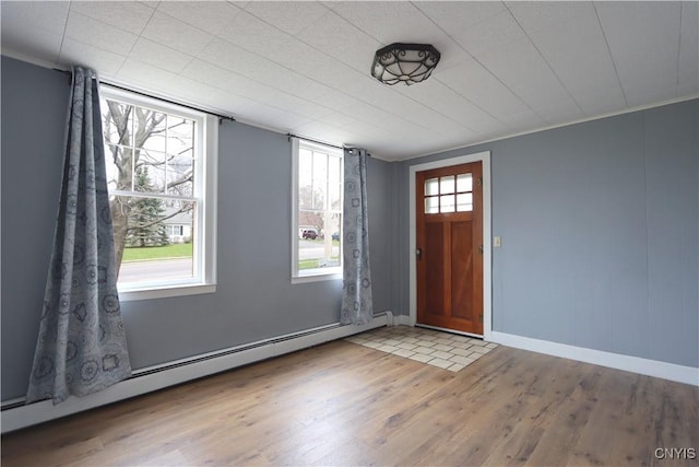 foyer with baseboards, wood finished floors, and baseboard heating