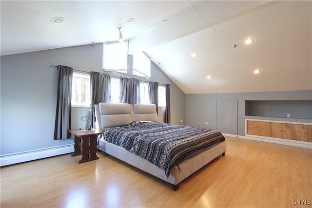 bedroom featuring baseboards, a baseboard radiator, lofted ceiling, and wood finished floors