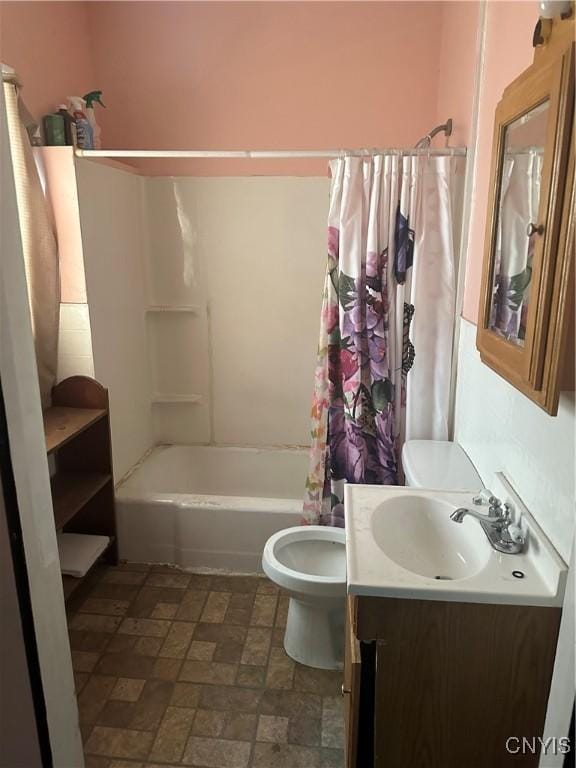 bathroom with vanity, shower / bath combo, toilet, and stone finish floor