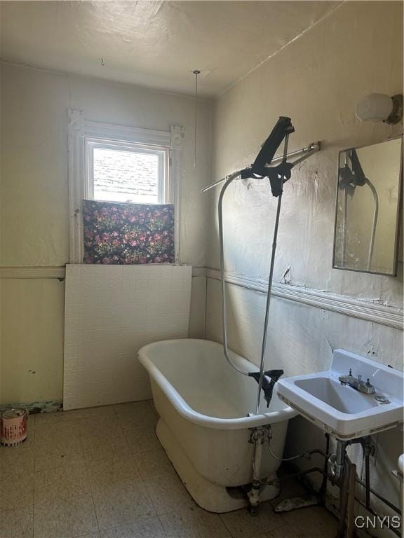 bathroom with a freestanding tub and tile patterned floors