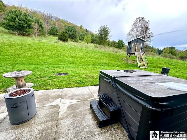 view of patio / terrace with a hot tub
