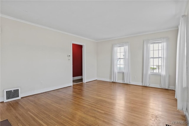 unfurnished room with baseboards, visible vents, ornamental molding, and light wood-style floors