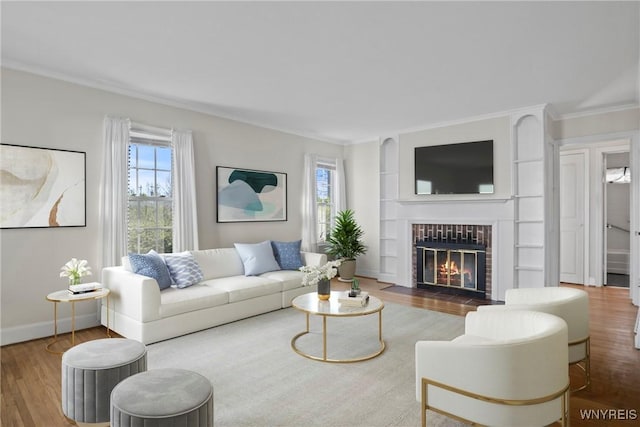living room featuring crown molding, a fireplace with flush hearth, a wealth of natural light, and wood finished floors
