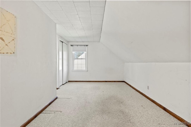 bonus room featuring vaulted ceiling, baseboards, and carpet flooring
