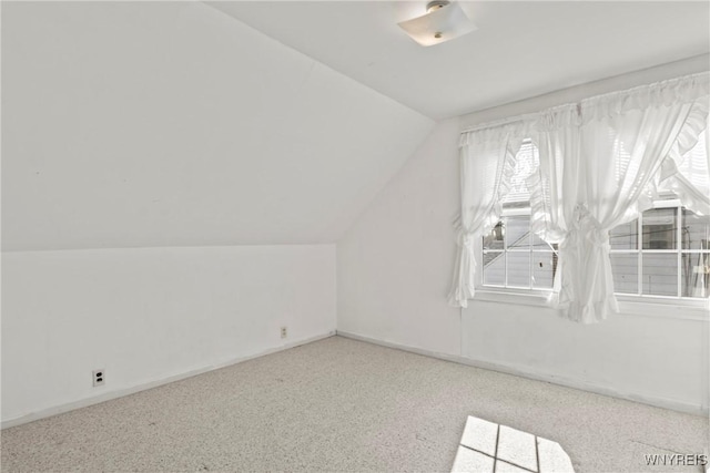 bonus room featuring carpet floors, baseboards, and vaulted ceiling