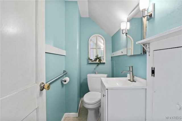 bathroom with toilet, baseboards, vaulted ceiling, and vanity