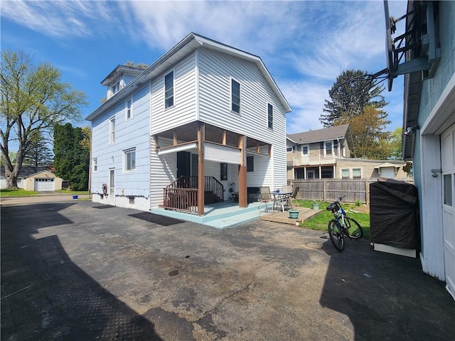 back of house with a patio and fence