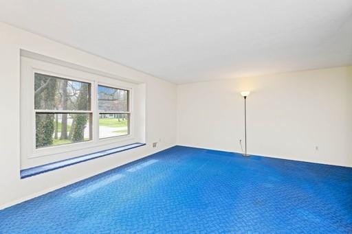 empty room featuring dark carpet