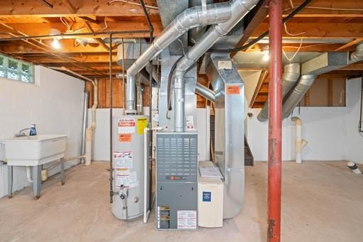 basement with water heater, heating unit, and a sink