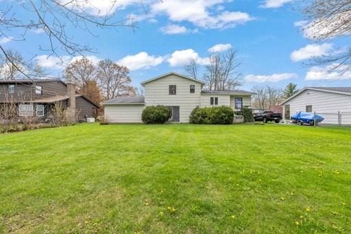 rear view of house with a yard