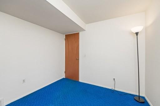 carpeted spare room with baseboards