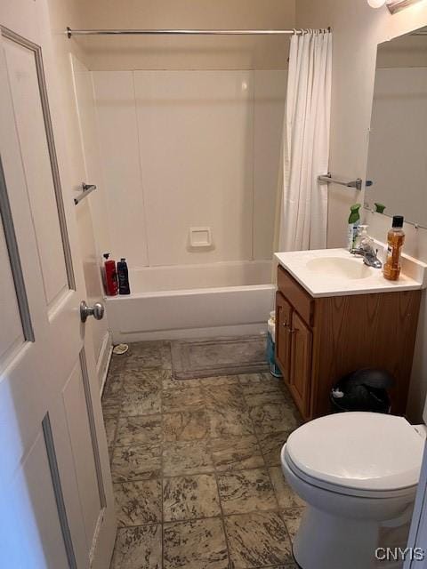 bathroom featuring vanity, shower / tub combo, and toilet