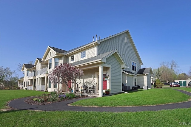rear view of property with a lawn