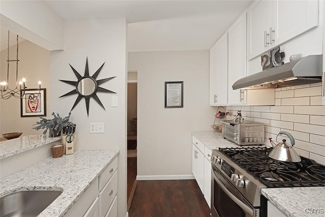 kitchen with stainless steel range with gas cooktop, light stone countertops, and under cabinet range hood