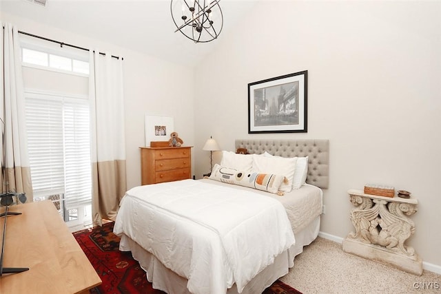 carpeted bedroom with baseboards and lofted ceiling